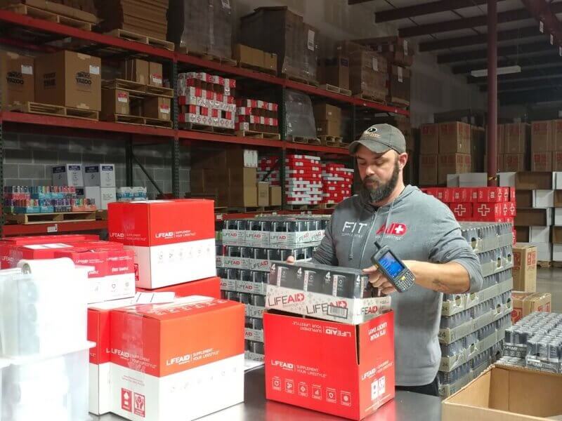 Man stacking boxes in warehouse