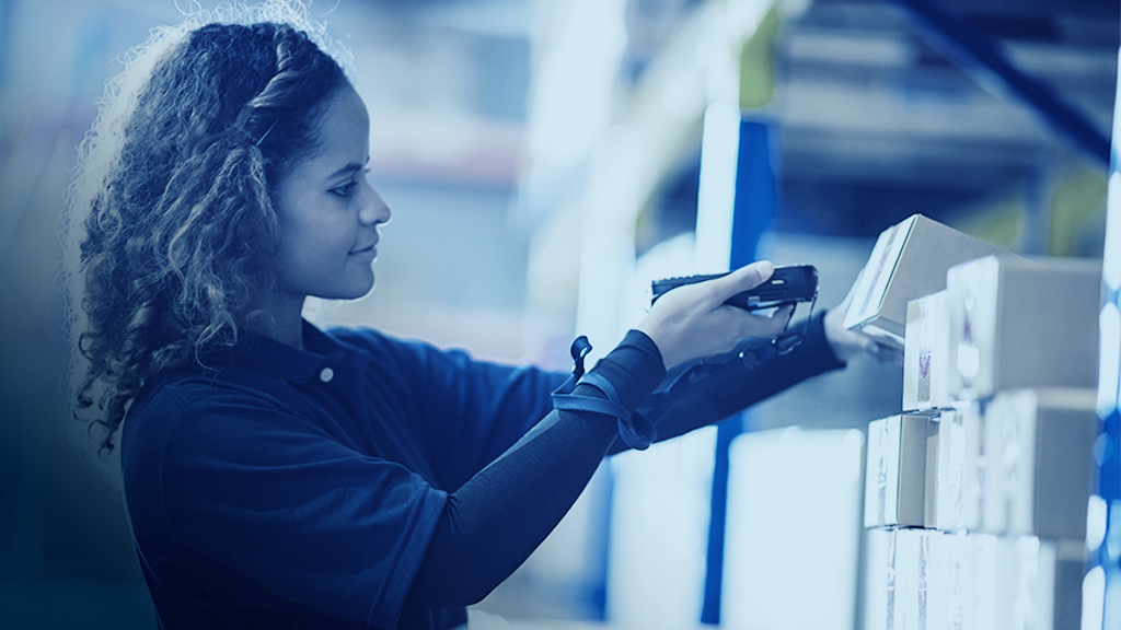 Warehouse worker using a barcode scanner to track a lot id or serial number on an inventory product