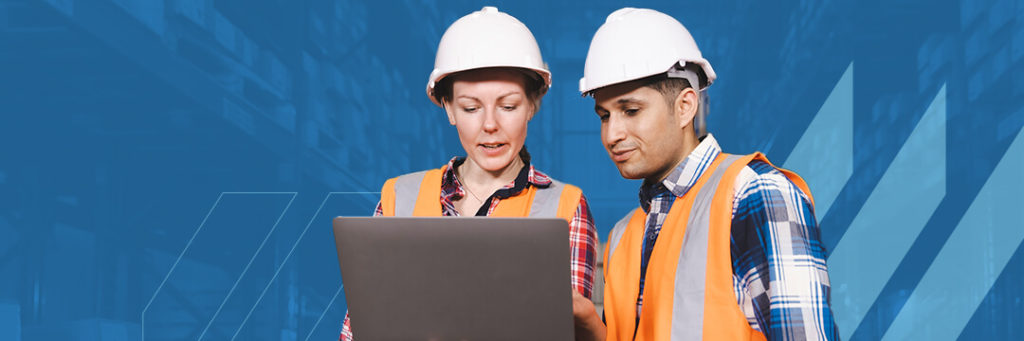 Warehouse workers reviewing physical inventory data on a laptop