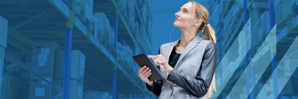 Woman holding tablet looking at stock in warehouse