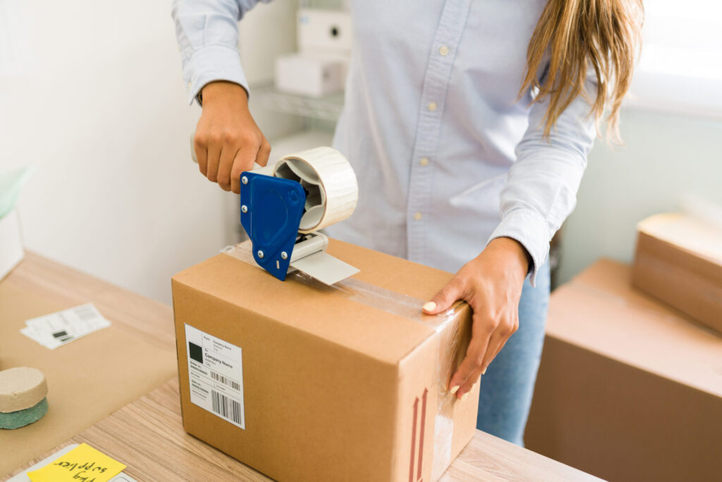 A seller packing an order, getting it ready to be shipped.