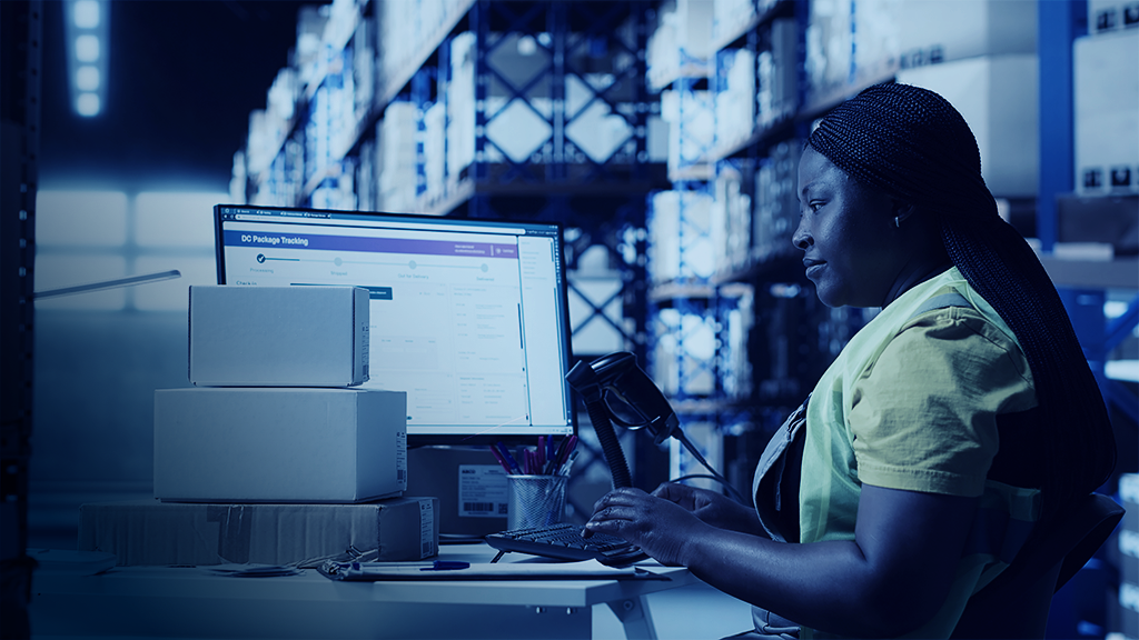 Female warehouse clerk registering barcodes for packages, scanning the shipping labels and awb tags on cardboard boxes. Fulfillment center distribution operations for e-commerce
