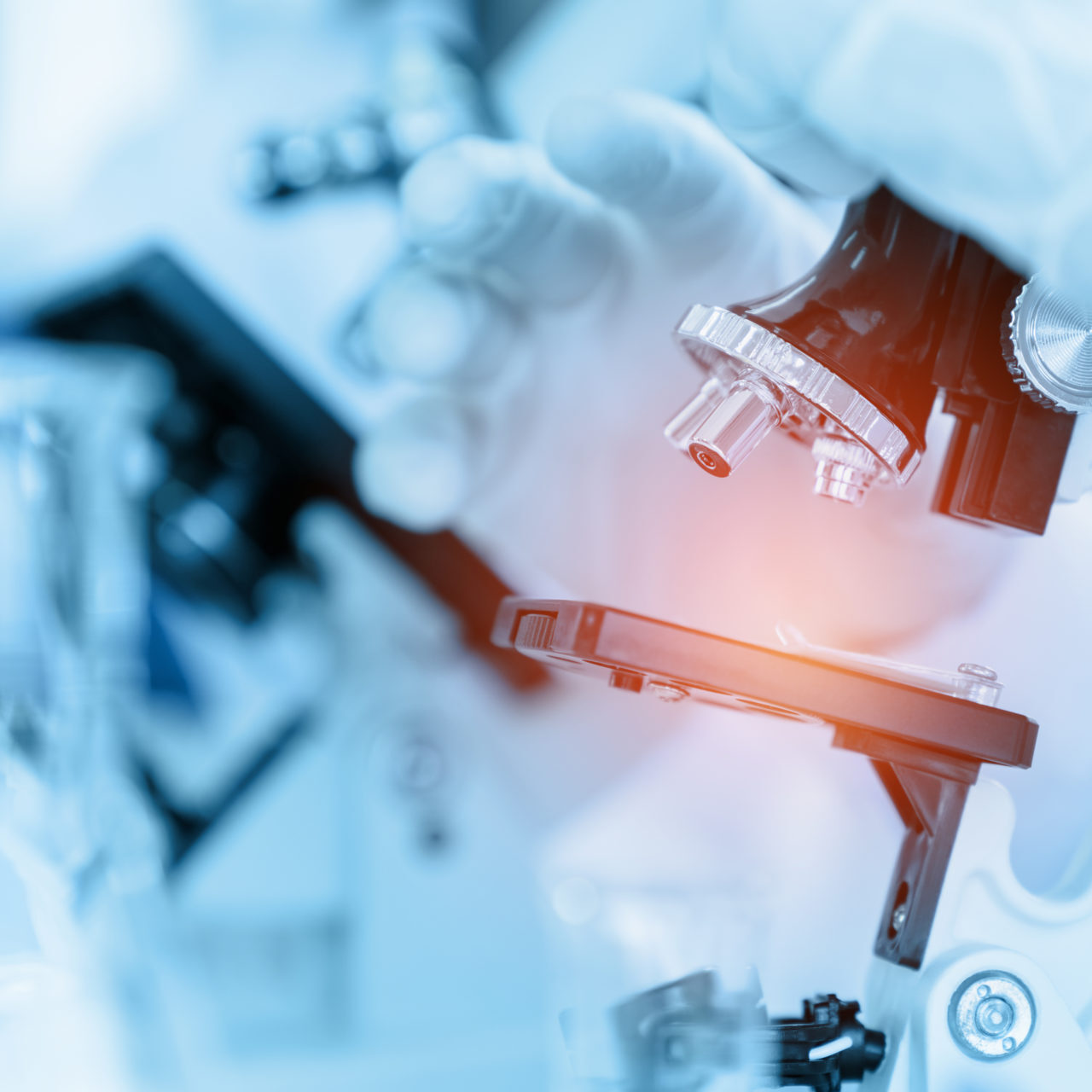 Close Up Scientist using microscope in laboratory room while making medical testing and research